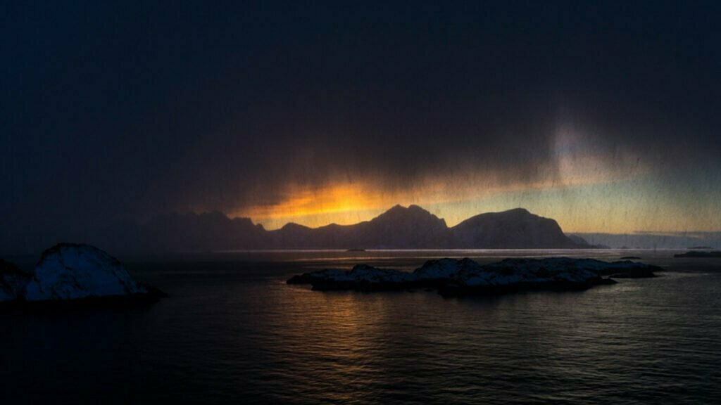 nyksund-view-to-sea-sunset-snow-incoming